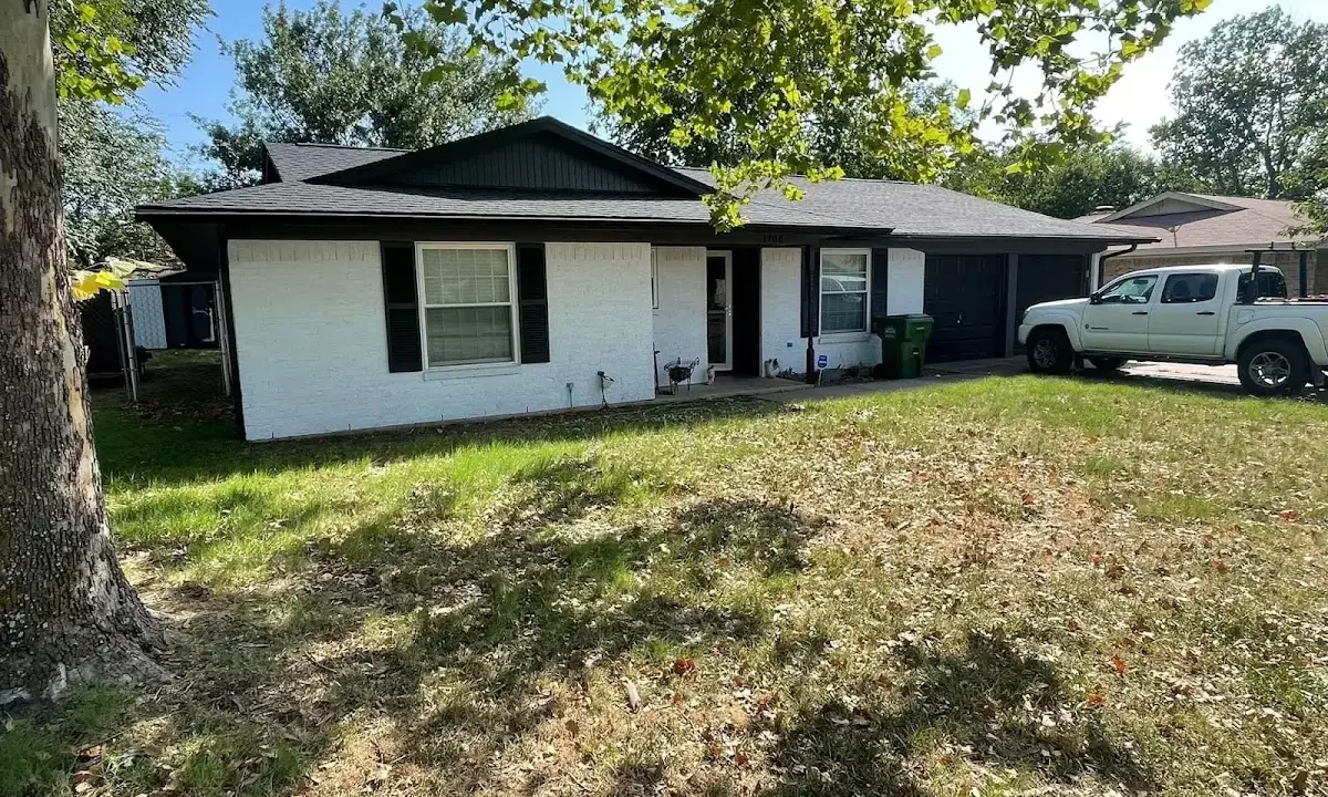 Professional roofing crew working on a residential roof in Greenwood Village